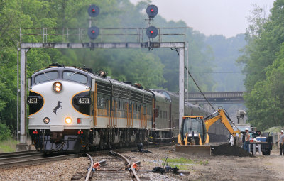 The old signal bridge at Kings Mountain frames the NS F units for the last time, as a crew prepares a foundation for new signals