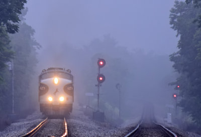The classic EMD Bulldog nose of NS 4271 appears through the pre-dawn fog as Southbound 955 eases past the signals at MP 115.2 