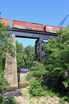 Train 116 crosses the Pittman Creek bridge as crews move a crane into posistion to raise the new span