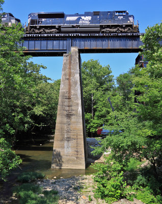 Train 116 crosses the Pittman Creek bridge as crews move a crane into posistion to raise the new span 