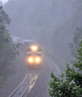 SR 8099 brings train 197 through the cut at Parkers Lake in the middle of a strong storm 