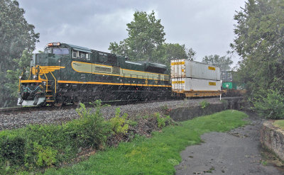 Erie 1068 shoves hard on the bottom of train 23G as they pass through Harrodsburg during an intense summer storm.