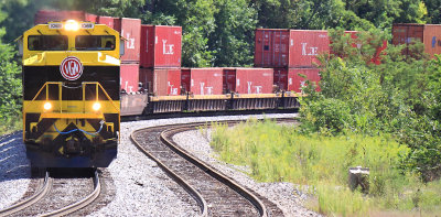 Yellow EMD and Red stacks..NS 22A winds through the curves at Waddy 