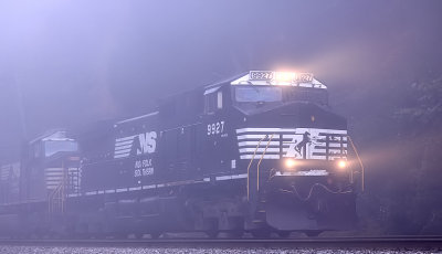 A Southbound grain train appears out of the fog after crossing the Cumberland River at Burnside 