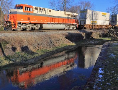 Interstate 8105 reflects in the waters of Town Branch creek as it trails train 23G through Harrodsburg 