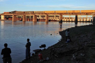 A few diehard fishermen reel in the last catches of the day as Northbound 288 crosses the Tennessee River just before sunset 