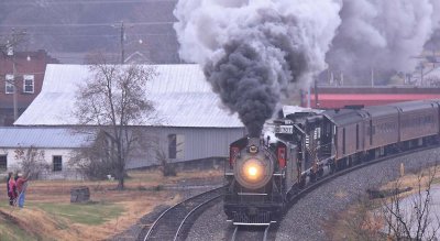 A few residents of White Pine brave the cool morning temps to watch 630 roll through town