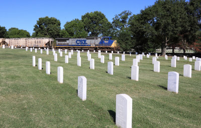 A Northbound empty grain train roars through the National Cemetery in Nashville