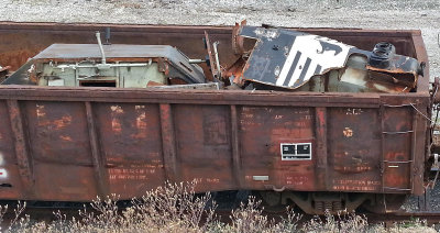 The high hood remains of a GP50 rest in a scrap gon outside the  Juniata shop 