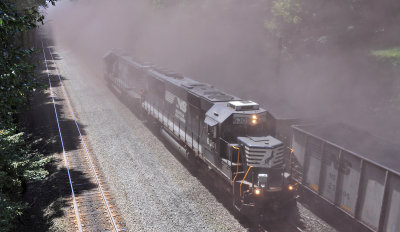 A fresh load of Westbound coal hits track speed for the first time, dusting a helper set  in the process 