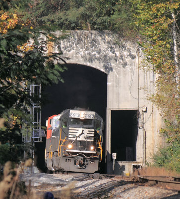 The familiar face of a EMD SD60 pops back into the sunlight at the South end of Tunnel 26 