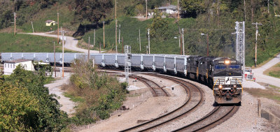 A Southbound grain train eases by the new signal mast at Oakdale. 
