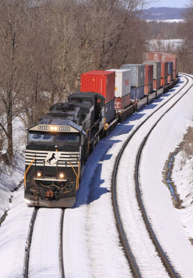 Eastbound 376 ambles through the snow covered siding at West Waddy 