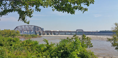 A CSX rack train crosses the PRR Ohio river bridge as it departs Louisville  for a run up the LIRC 