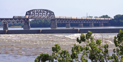 A CSX rack train crosses the PRR Ohio river bridge as it departs Louisville  for a run up the LIRC