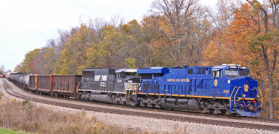 A little Fall color hangs on in the trees as NS 167 tops over Waddy Hill 