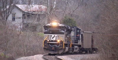 An old house watches from the hill as a Westbound coal train descends Waddy hill 