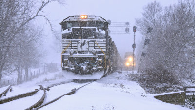 376 waits in the siding as the DP units on 75W disappear into the snow 