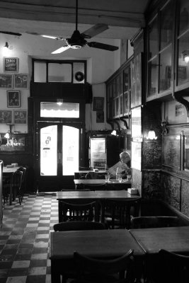 Buenos Aires, bar at Plaza San Telmo; Leão reading a newspaper.