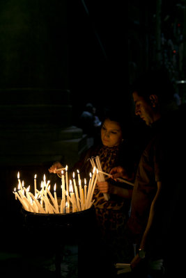 Pilgrims lighting candles