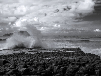 brakers crashing on flat rock