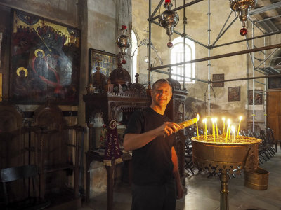 Lighting candles in the Church of the Nativity