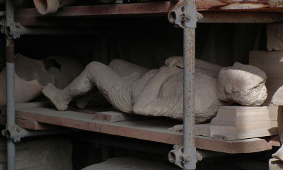 Plaster cast of body in store near cafeteria Pompei