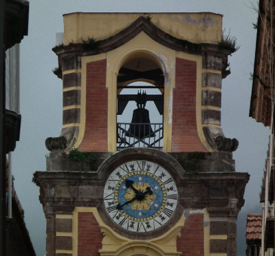 Bell tower and clock of main white cathedral Sorrento