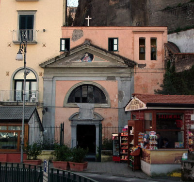 Small church by cliffs and harbour