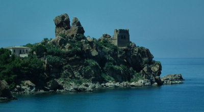 Cephalu tower and rocks at harbour entrance from coach