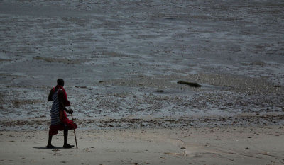 Maasai Michael walking the beach at low tide