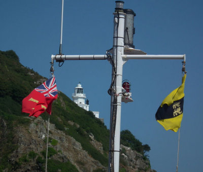 Sark_lighthouse and ferry flags from Maseline Harbour