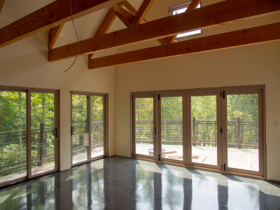 Deck room with finished floor and beams unwrapped