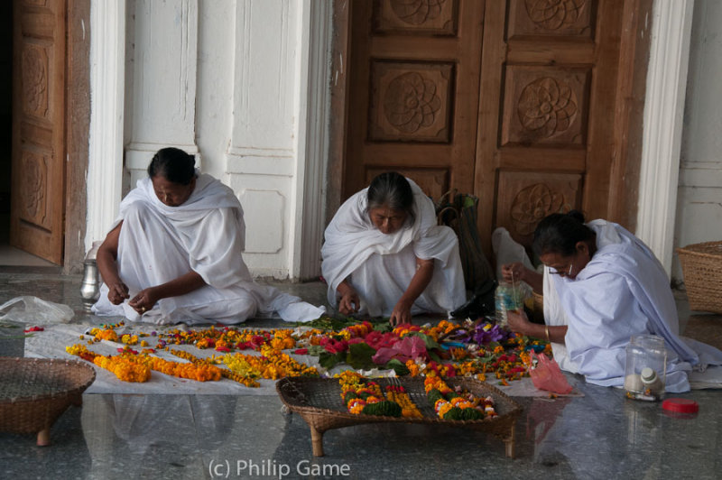 Women preparing garlands at the Shri Govindajee Mandir (temple)