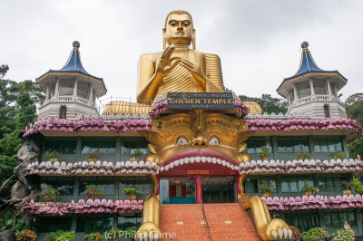 A grotesque Golden Buddha greets those arriving at Dambulla