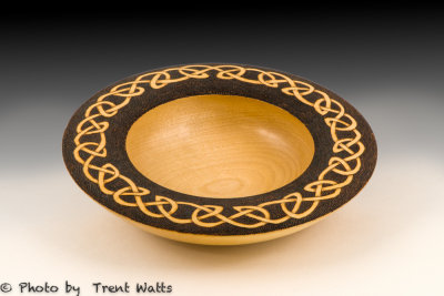 Turned bowl with Celtic knot rim.
