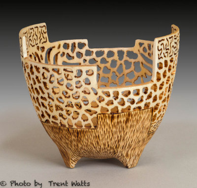 Turned, carved and pierced vessel with pyrographic highlights.