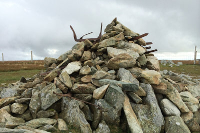 Tangled posts in summit cairn