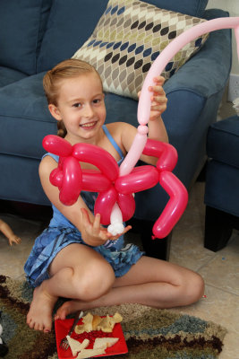 Balloon art! (some sort of puppy dog on a leash)