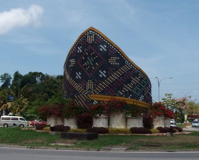 A traditional Malay men's hat as roadside monument