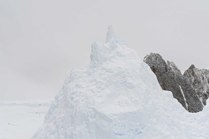 Iceberg against the Mountains