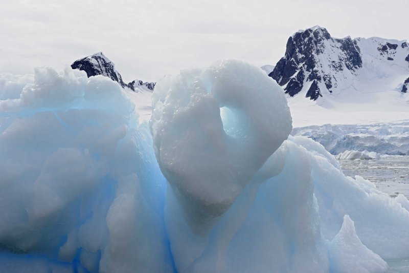 Blue Iceberg framed by Mountains