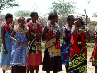 The women gather to sing a song for us
