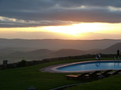 Having traditianal sundowners as the sun set over the pool