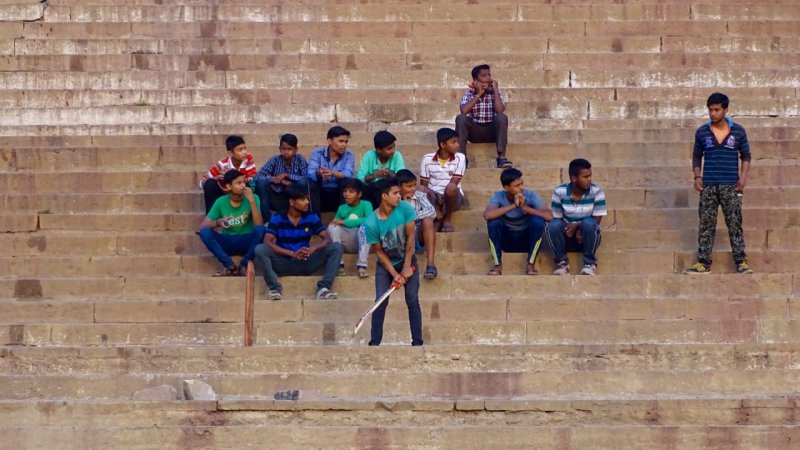 Kids playing cricket on the bank of the Ganges