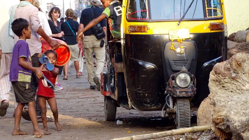 Kids playing in a Tuk Tuk near the Ganges