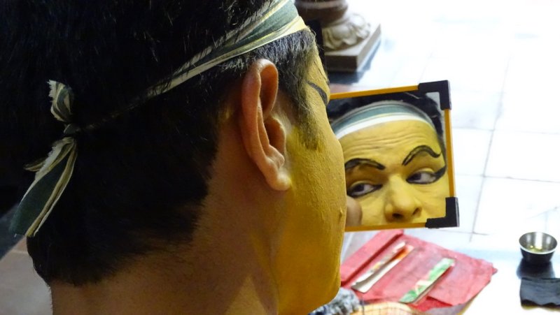 Kathakali Performer Applying Makeup