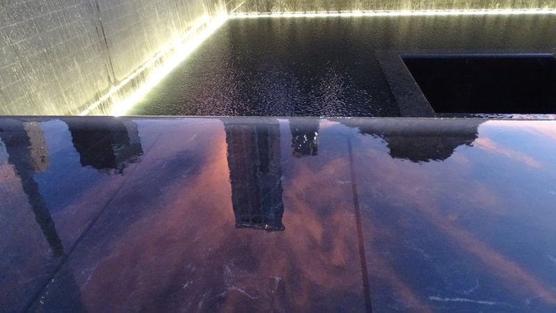 9/11 memorial reflecting pool at sunset