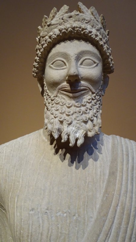 Limestone votary of a bearded male with a wreath