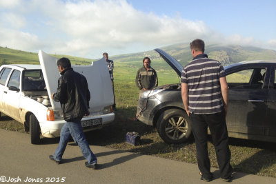 Azerbaijan (Zuvand region) - Dan, Ashley and myself with a local folk trying to figure out how to recharge our car battery!